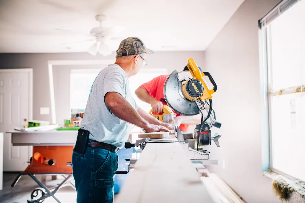 Plumber repairing the internal components of a toilet tank